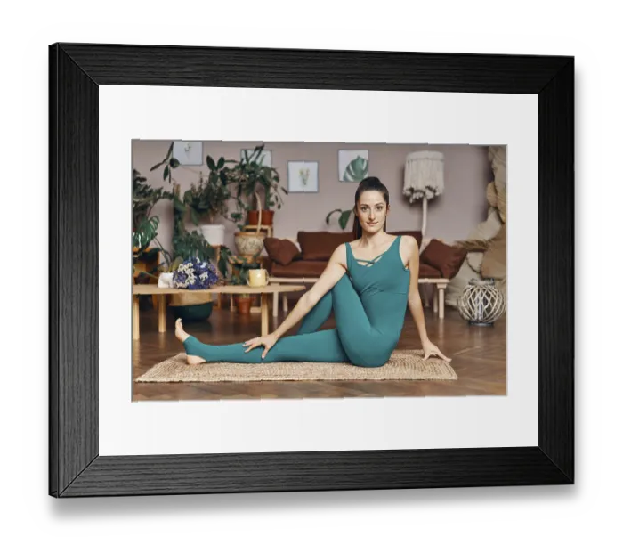 Framed Print : Young sporty woman practicing yoga at home doing half lord of the fishes pose