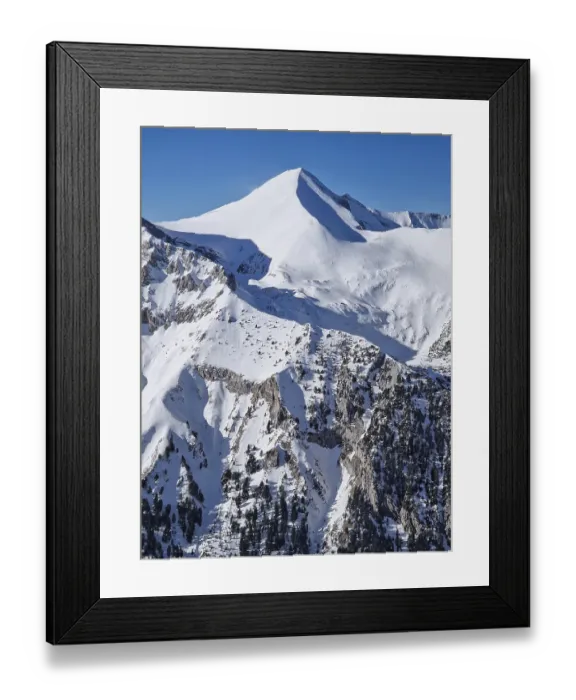 Framed Print : Closeup view to the rocky mountain peak covered with snow Framed Print : Closeup view to the rocky mountain peak covered with snow