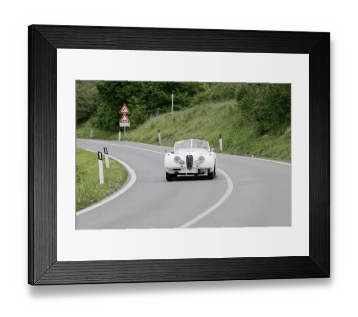 Framed Print : Classic white car on a winding road in a green landscape Framed Print : Classic white car on a winding road in a green landscape