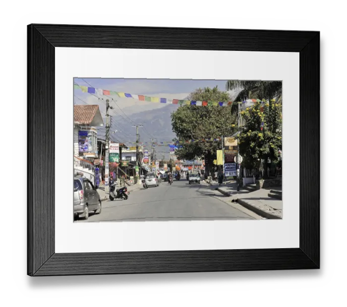 Framed Print : Busy street in a Nepalese town with shops and fluttering prayer flags