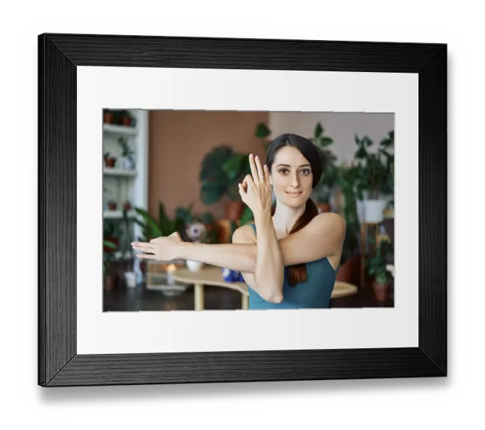 Framed Print : Young sporty woman practicing yoga at home