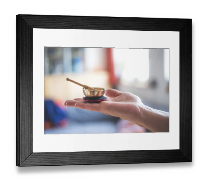 Framed Print : Small singing bowl holding in hand