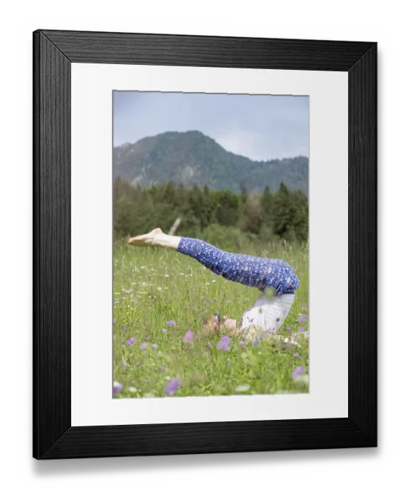 Framed Print : Young girl is doing yoga in the park