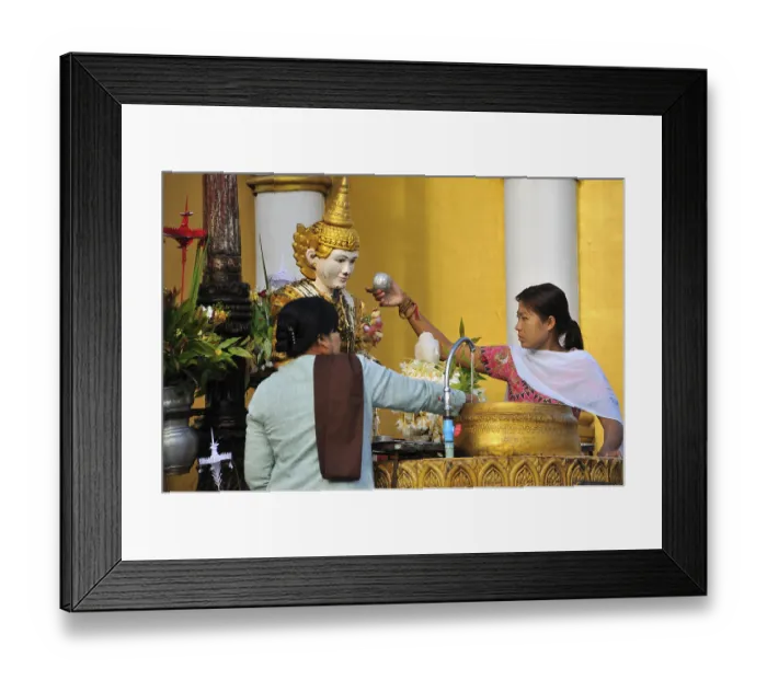 Framed Print : Two women pouring water onto a statue