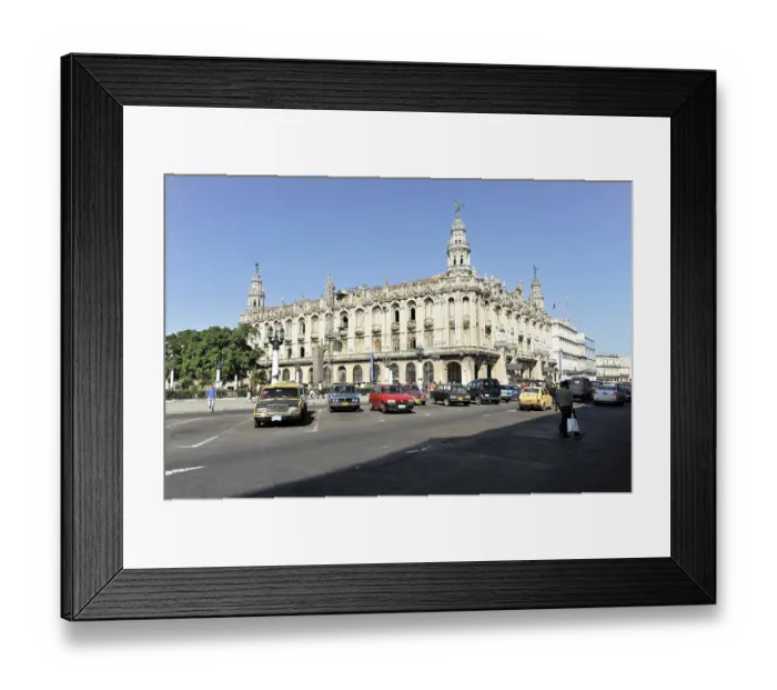 Framed Print : Busy street scene with historic building and vintage cars in the city by daylight