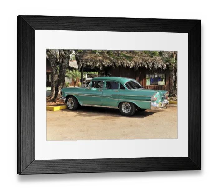 Framed Print : Green and white vintage car in perfect condition parked in front of a building in tropical Cuba Framed Print : Green and white vintage car in perfect condition parked in front of a building in tropical Cuba
