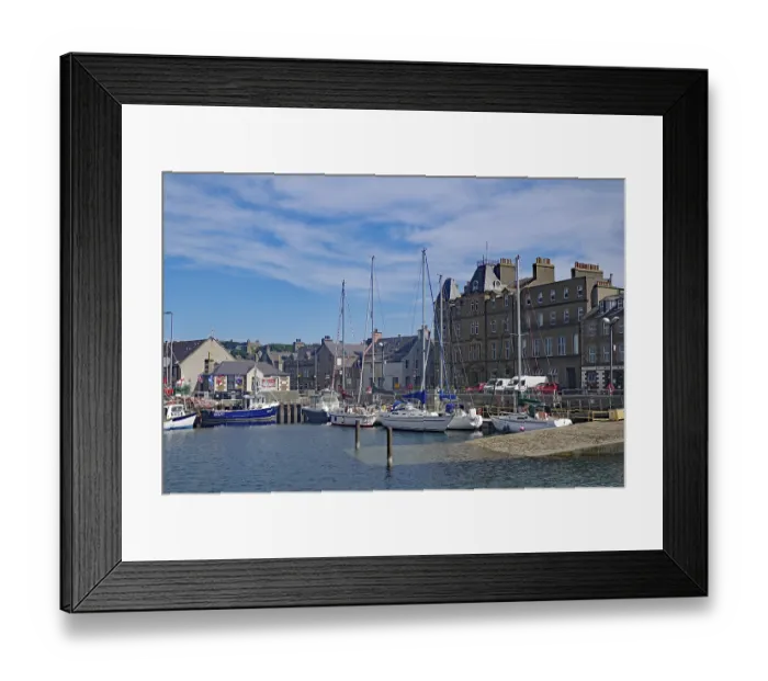 Framed Print : Coastal harbour with sailing boats and historic buildings under a bright blue sky Framed Print : Coastal harbour with sailing boats and historic buildings under a bright blue sky