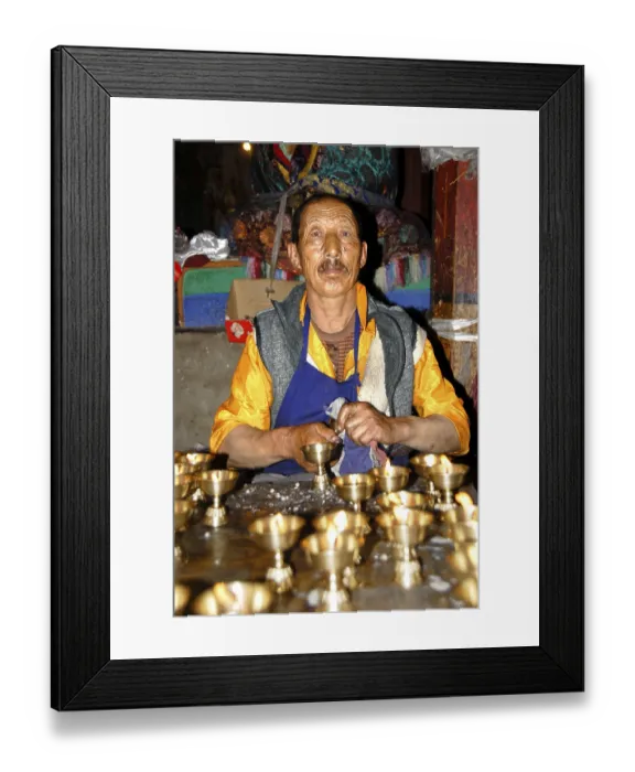 Framed Print : Tibetan monk cleans jars for yak butter lamps carefully Samye Monastery Tibet China