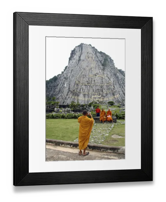 Framed Print : Monks taking a photograph of a Buddha image on a cliff