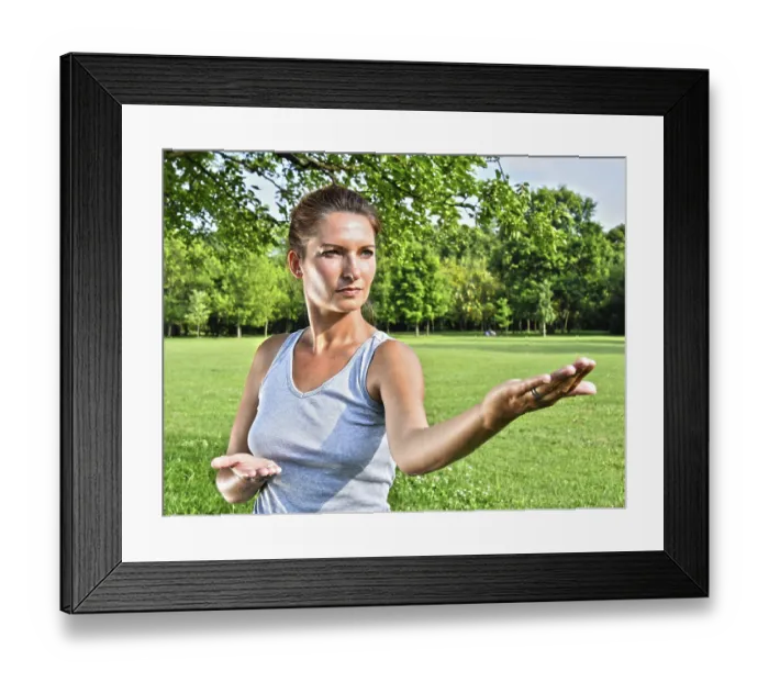 Framed Print : Young woman during tai chi exercise in the park