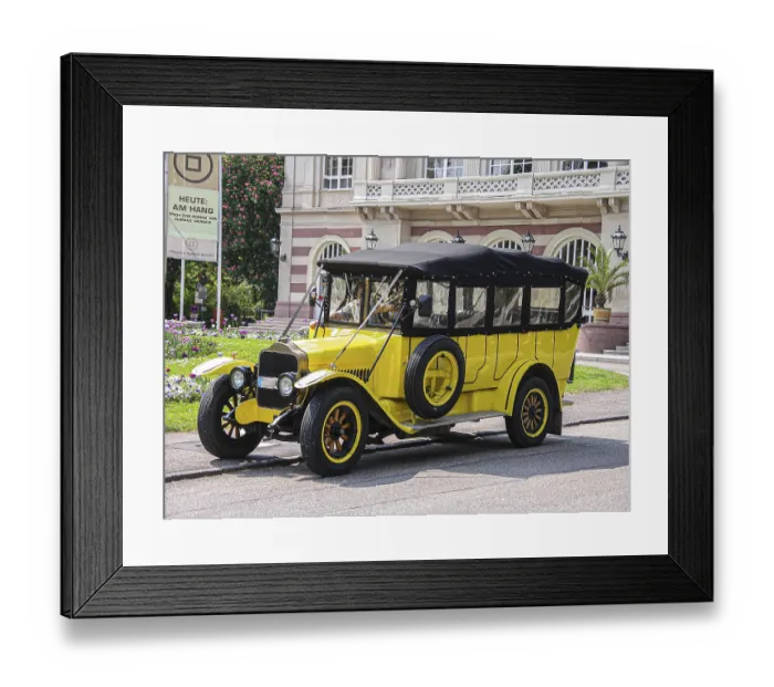 Framed Print : Yellow vintage bus in front of theatre