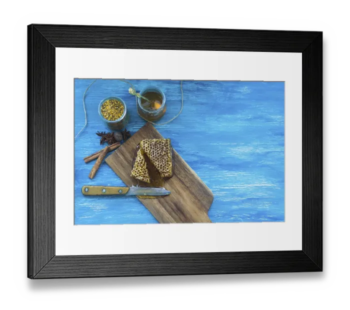 Framed Print : Bee pollens jar spices honeycomb piece with knife against blue textured background