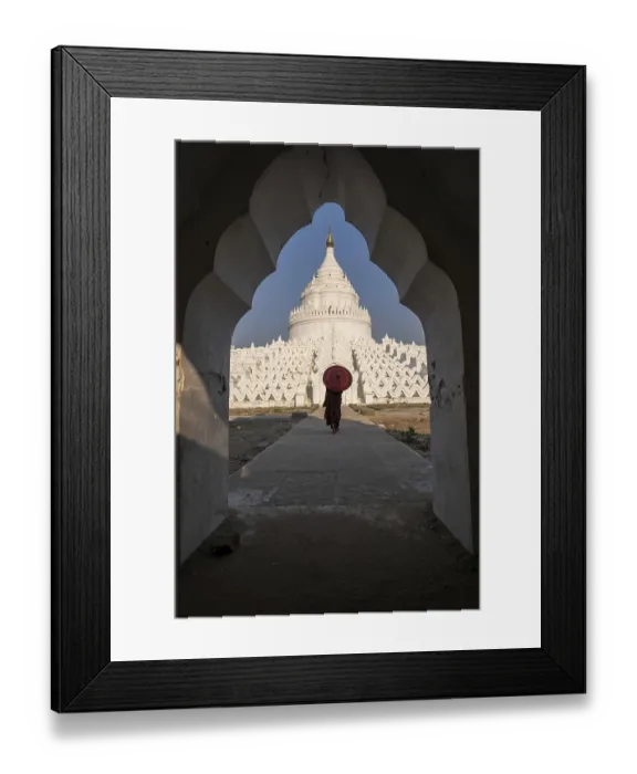 Framed Print : Buddhist monk stands with red umbrella in front of Hsinbyume Pagoda with frame of another pagoda