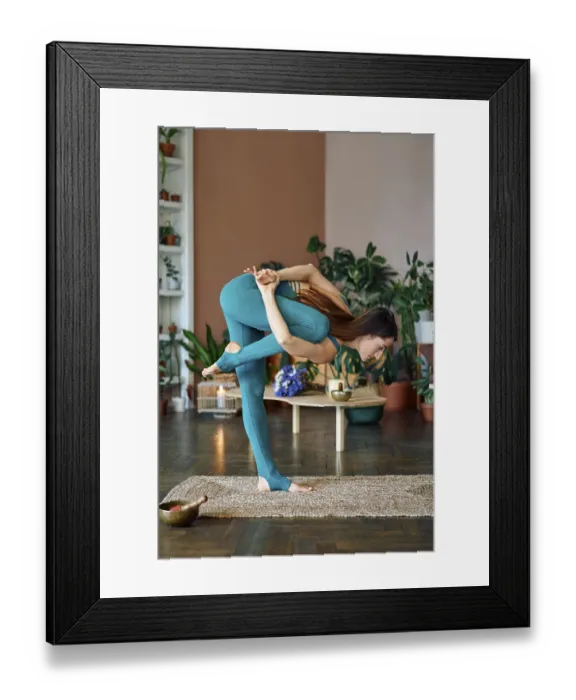 Framed Print : Young sporty woman practicing yoga at home doing balance asana standing marichyasana