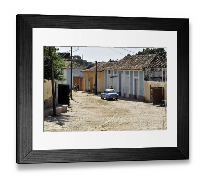 Framed Print : A quiet, sunny Cuban street with vintage cars and traditional architecture