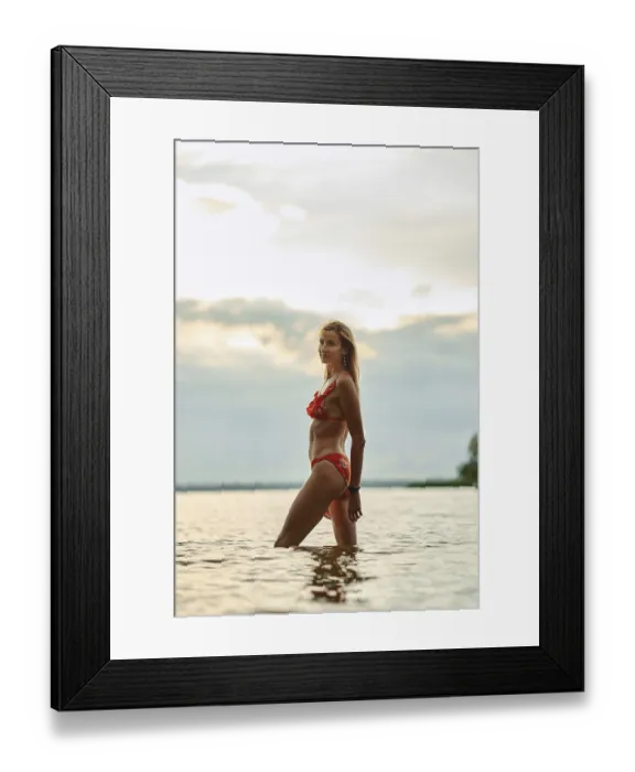 Framed Print : A woman in a red bikini walks through calm waters Framed Print : A woman in a red bikini walks through calm waters