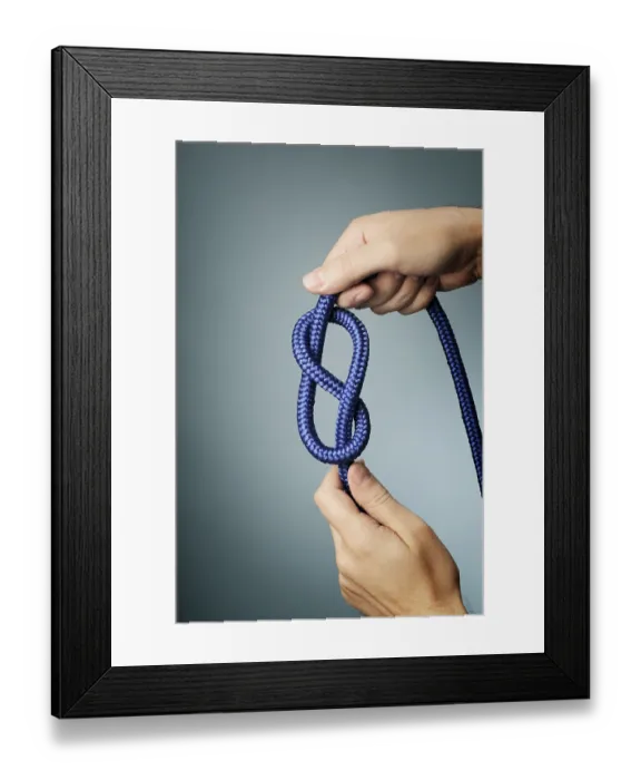 Framed Print : Man holding blue rope with figure of eight knot in his hands
