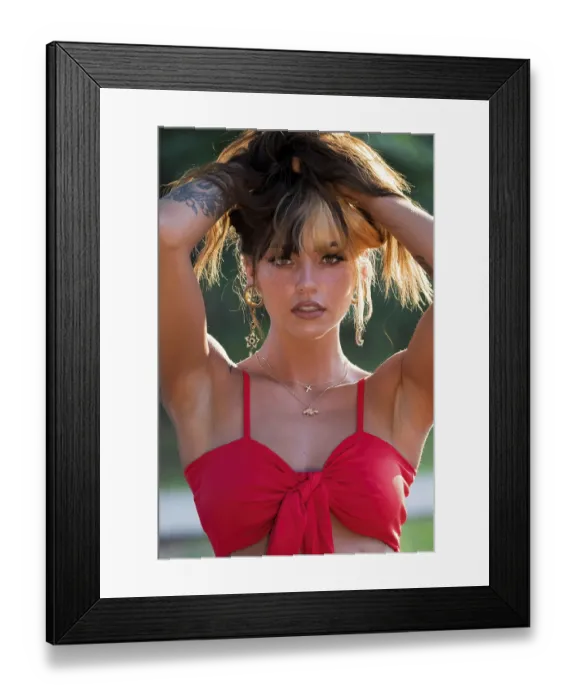 Framed Print : A gorgeous brunette model poses outdoors while enjoying the summer weather