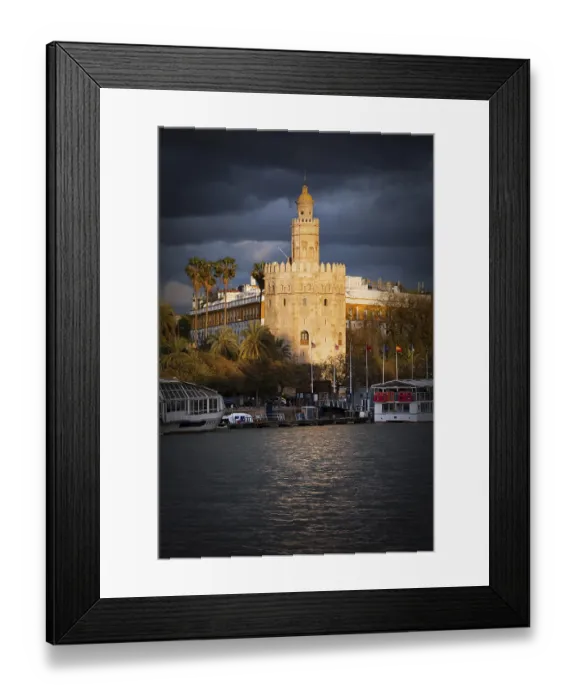 Framed Print : Gold Tower (Spanish: Torre del Oro) of Seville bathed in last rays of the setting sun before the storm