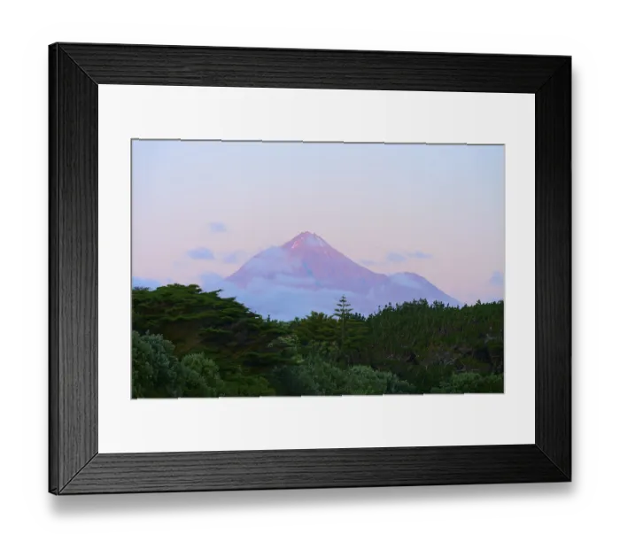 Framed Print : Volcano Mount Taranaki at dusk with clouds and surrounding vegetation