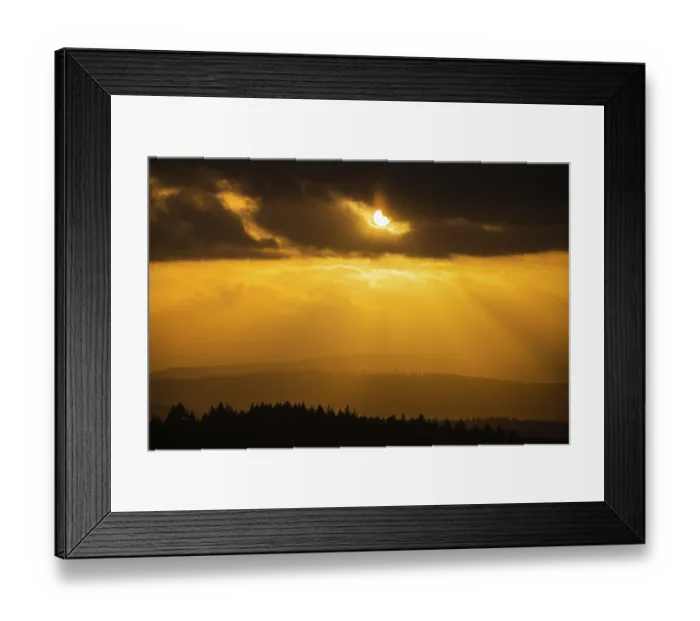 Framed Print : A Dramatic Sunset in the Evening with Clouds over a Valley in the Forest