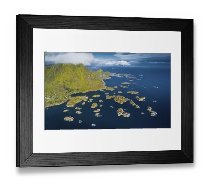 Framed Print : Road to Henningsvaer, numerous small rocky islands in the sea in front of green Lofotenberg