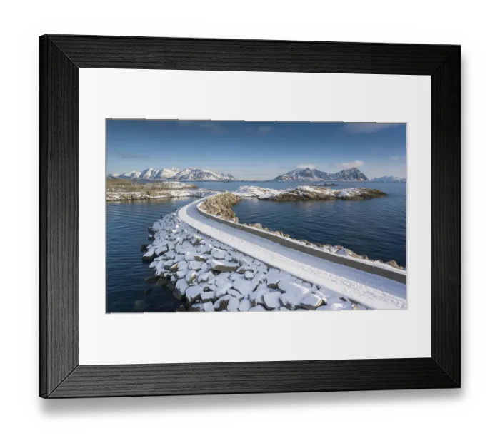 Framed Print : Snowy jetty in the sea, mountains in the back