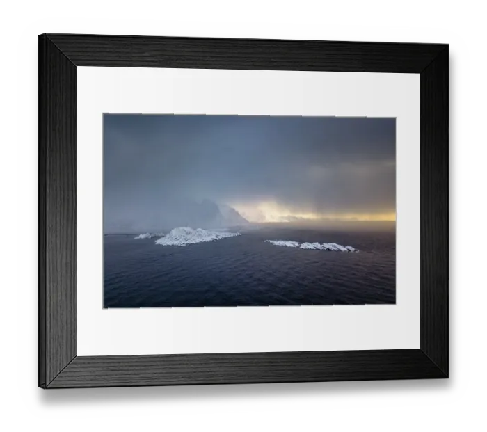 Framed Print : Snowfall over the sea and mountains