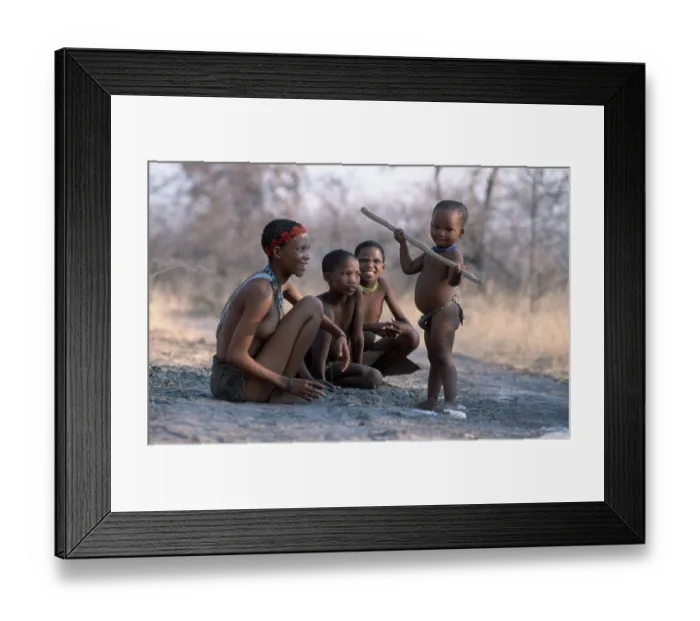 Framed Print : Bushman woman with children, child plays with stick Framed Print : Bushman woman with children, child plays with stick
