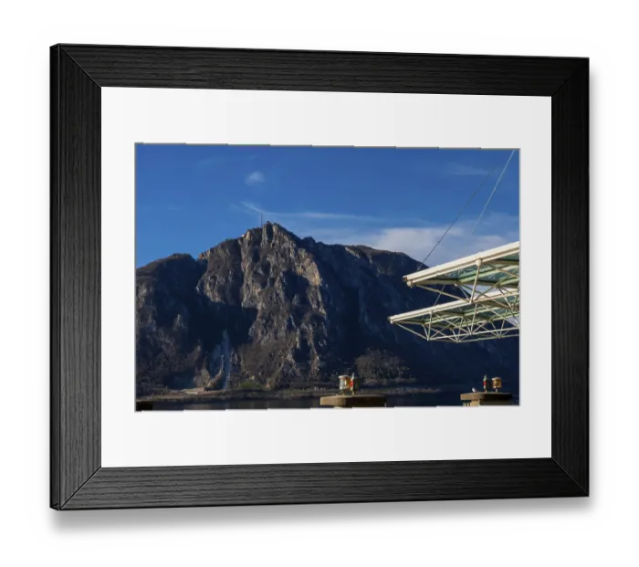 Framed Print : Modern Building Roof Against Blue Sky and Mountain Peak San Salvatore on Lake Lugano in Campione d'Italia