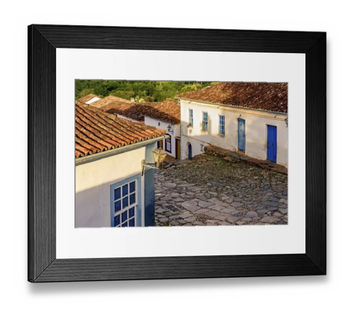 Framed Print : Paving stones made by slaves on the streets with colonial-style houses in the city of Tiradentes built in the 18th
