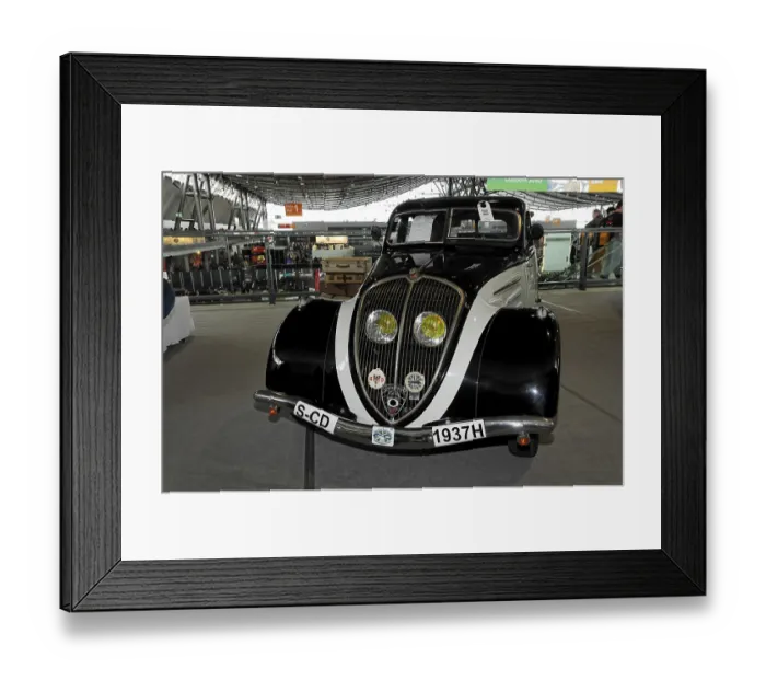 Framed Print : An elegant black vintage car from 1937 with chrome details and yellow headlights