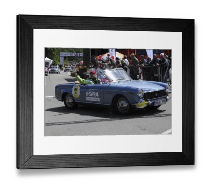 Framed Print : A blue open-top vintage rally car with a smiling driver in front of spectators Framed Print : A blue open-top vintage rally car with a smiling driver in front of spectators
