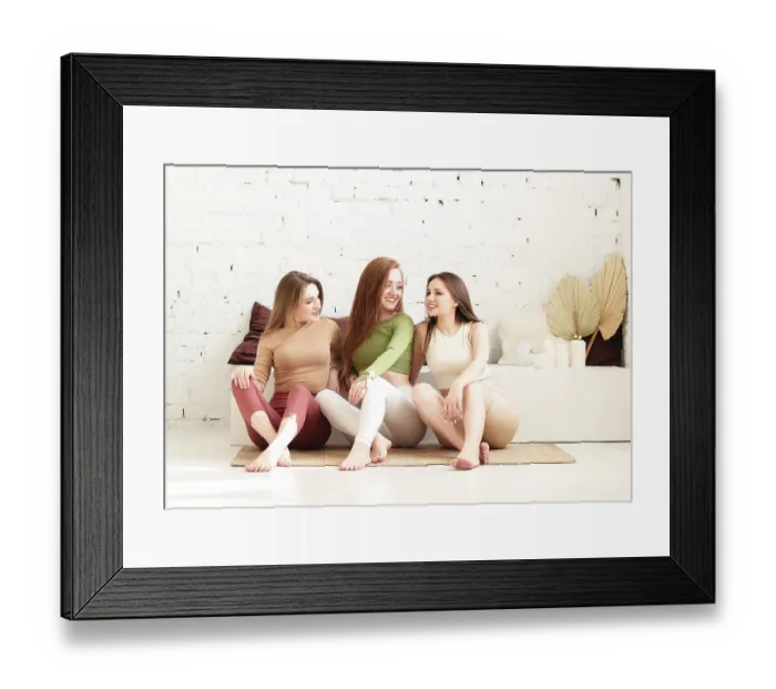 Framed Print : Happy young women smiling after meditating against white brick wall during yoga session