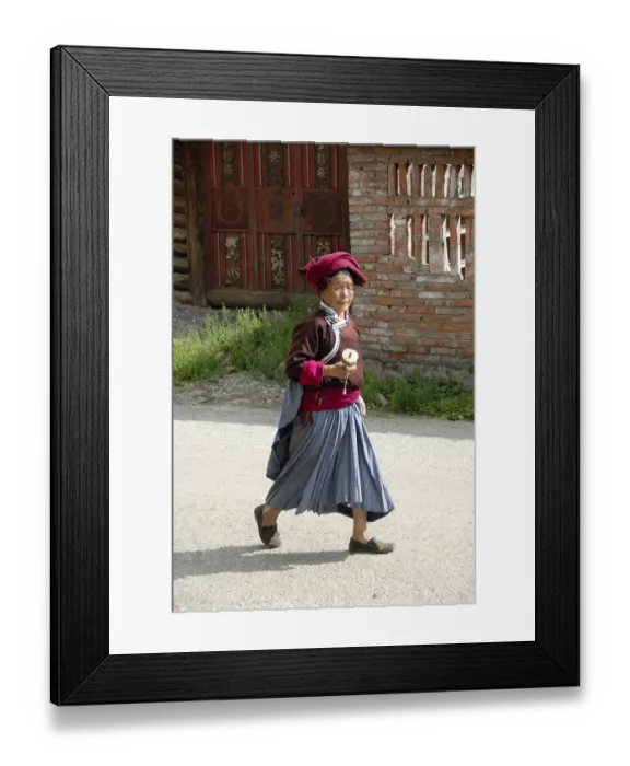 Framed Print : Tibetan Buddhism, ethnology, woman of the Mosu ethnicity dressed in traditional costume swinging a prayer wheel