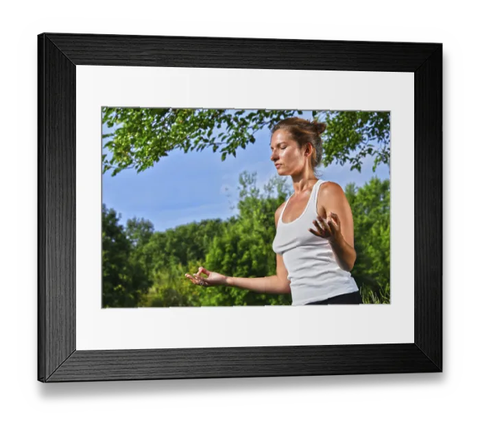 Framed Print : Young woman during yoga meditation in the park