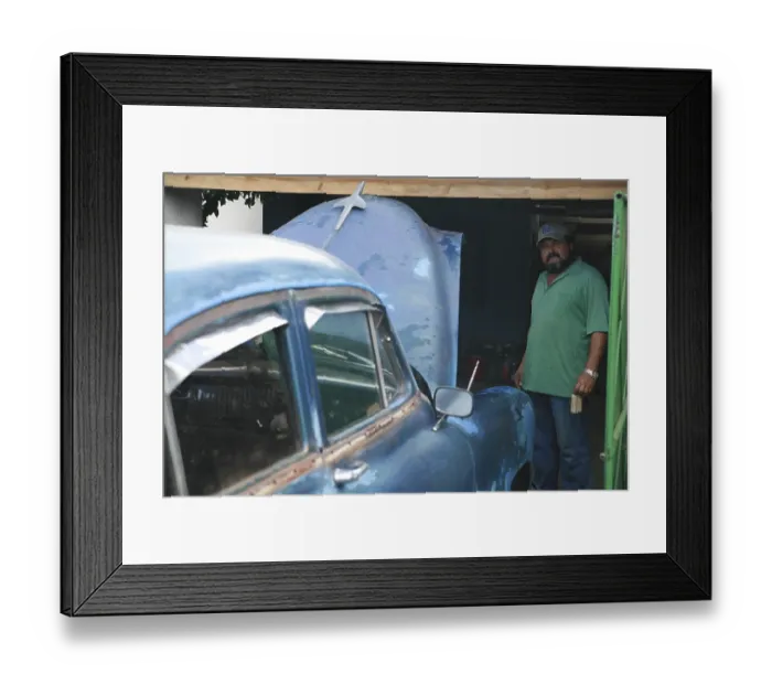 Framed Print : Cuban standing next to his car as it is serviced Framed Print : Cuban standing next to his car as it is serviced