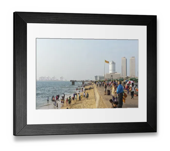 Framed Print : People walk along the beach promenade Framed Print : People walk along the beach promenade