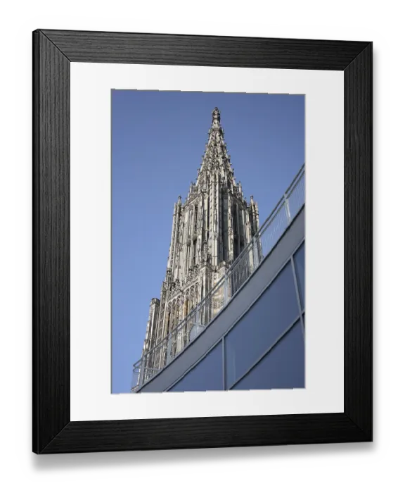 Framed Print : Steeple of Ulm Cathedral behind the glass facade of the Town Hall