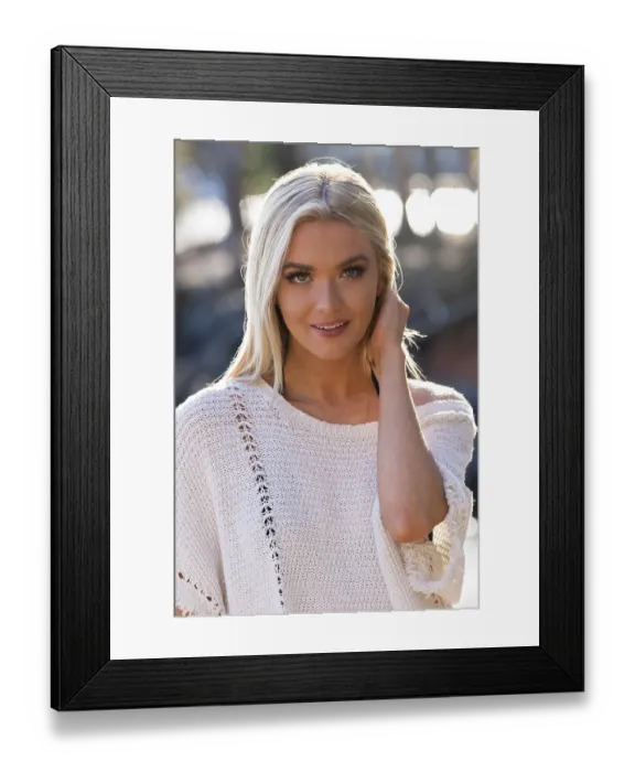 Framed Print : A gorgeous blonde bikini model poses outdoors near a lake while enjoying the summer weather