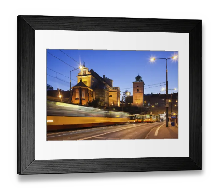 Framed Print : Evening traffic on the Solidarity Avenue and illuminated St Anne Church in Warsaw