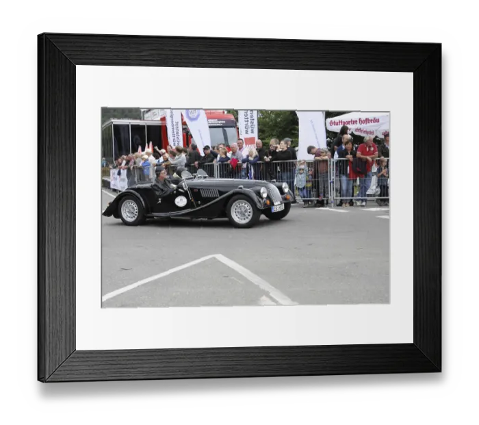 Framed Print : A black convertible classic car at a racing event with spectators in the background Framed Print : A black convertible classic car at a racing event with spectators in the background