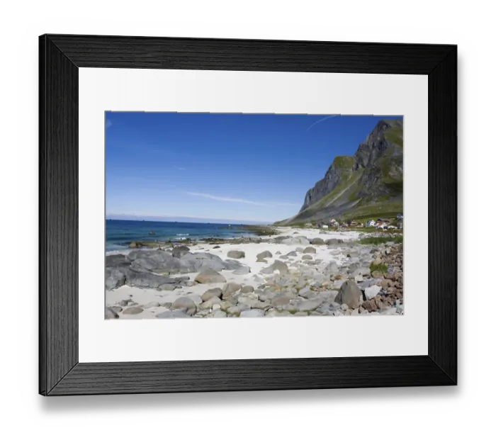 Framed Print : An idyllic sandy beach with rocks and clear water against a backdrop of mountains and blue skies Vikten Lofoten