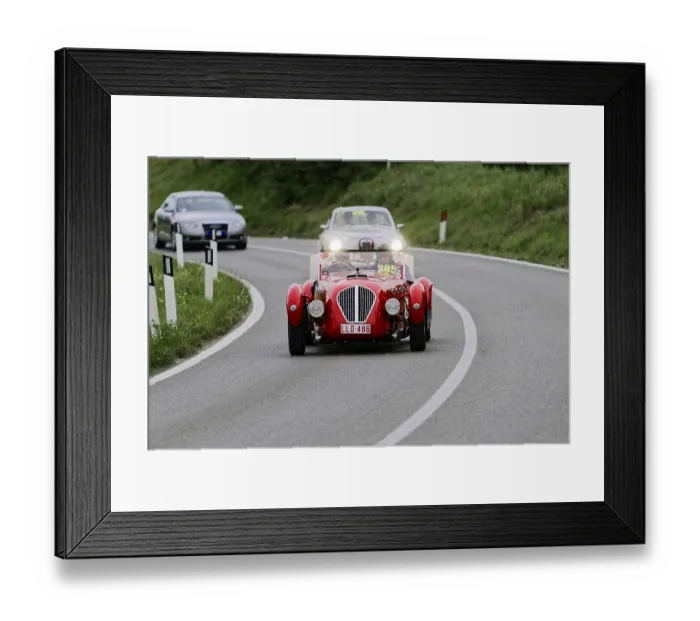 Framed Print : A red classic car on a winding road during a rally Framed Print : A red classic car on a winding road during a rally