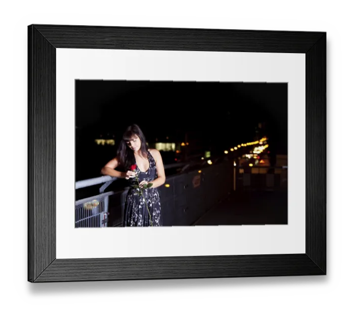 Framed Print : Woman with a red rose above the city outdoors