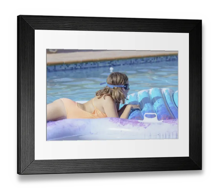 Framed Print : Cute girl lying on an inflatable mattress in the pool Framed Print : Cute girl lying on an inflatable mattress in the pool