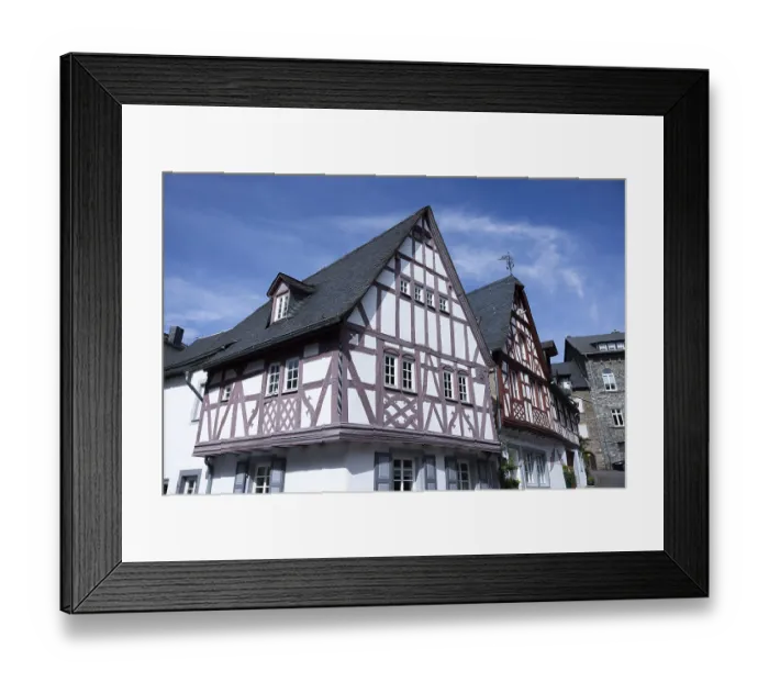 Framed Print : Historic half-timbered house against a clear blue sky in an urban setting Framed Print : Historic half-timbered house against a clear blue sky in an urban setting