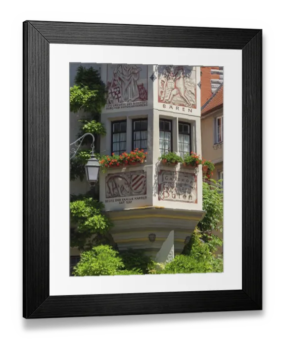 Framed Print : A decorated half-timbered house with murals and red geraniums in full bloom Framed Print : A decorated half-timbered house with murals and red geraniums in full bloom