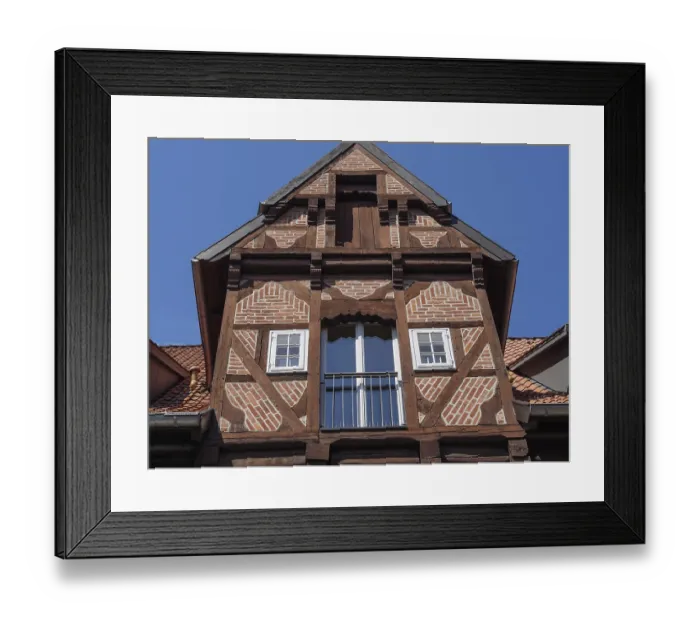 Framed Print : Close-up of a historic half-timbered house with striking wooden structure