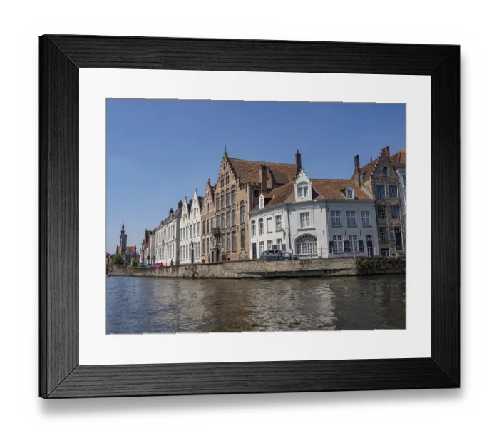 Framed Print : Row of historic buildings along a canal with detailed architecture and clear sky